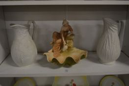 A Royal Dux porcelain figural bowl together with two relief moulded jugs.