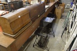 Three sewing machines and a cast iron sewing machine base.