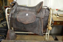 A leather gaucho saddle complete with set of bolas.