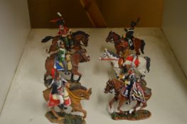 Six painted cast metal military figures on horseback.