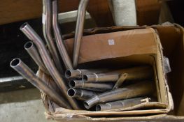 Unused steel motorbike exhaust parts.