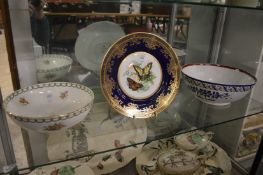 A decorative plate and two bowls.