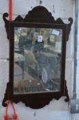 A small fretwork framed mahogany mirror.