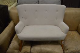 A miniature button back sofa.