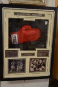 A Sugar Ray Leonard signed boxing glove mounted in a display case with associated material.