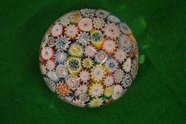 A Millefiori glass paperweight.