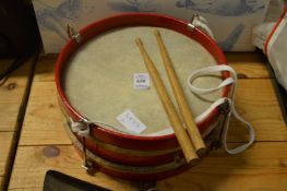 A drum and drum sticks.