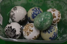 Six decorative porcelain balls and a hardstone egg.