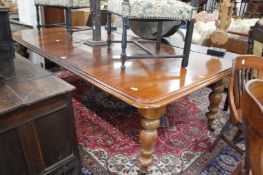 A Victorian mahogany extending dining table with three leaves on turned octagonal baluster shaped