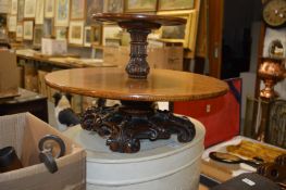 An oak two tier lazy susan with carved base.