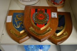 Three military related shield shaped plaques.