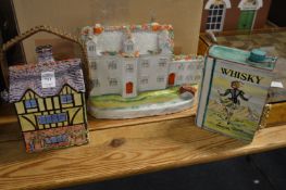 A cottage shaped biscuit jar, Staffordshire flatback figure of Stanfield Hall and a book shaped