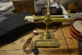 A brass desk lamp.