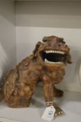 A grotesque pottery model of a lion dog.
