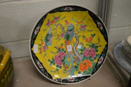 A large Japanese charger decorated with an exotic bird.