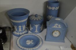 A group of blue jasperware items to include a mantle clock, vases etc.