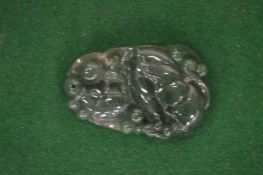 A Chinese carved jade amulet.