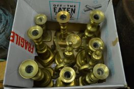 Brass candlesticks and a pair of firedogs.