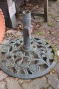 A cast metal parasol base.