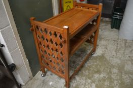 A teak drinks trolley.