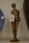 A bronze figure a standing female nude.