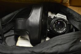 An Olympus OM10 camera with accessories and bag.