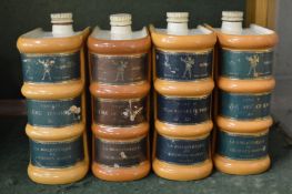 A set of four French pottery book shaped liqueur bottles.
