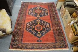A Persian style carpet with two central large medallions 190cm x 130cm.