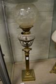 A brass corinthian column oil lamp.