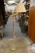 A brass floor standing lamp.