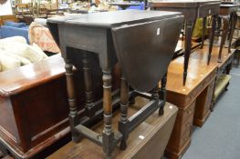 An oak dropleaf gateleg dining table.