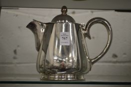 A plated hot water jug.