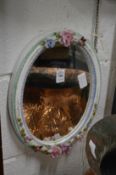 A porcelain oval mirror.