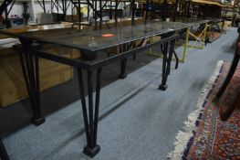 A modern glass top coffee table with black painted metal frame.