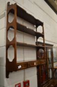 Mahogany hanging wall shelves with three small drawers.
