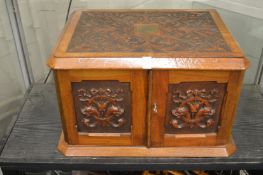 A very good Victorian carved walnut two door table top canteen, the pair of doors enclosing four
