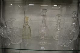 A good group of glassware to include three decanters, claret jug, large cut glass jug, pair of