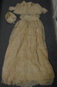 A lace christening dress and another dress.