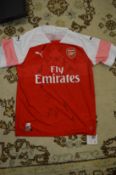 An official signed Arsenal football club shirt, with original box and certificate.