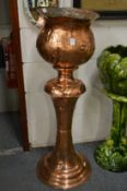 An Art Nouveau style copper jardiniere with stand.