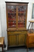 An Edwardian inlaid mahogany cupboard bookcase.
