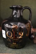 A pottery jug containing QE2 single malt scotch whisky.