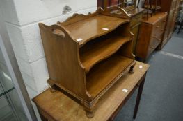A mahogany magazine rack.