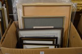 A box of paintings and prints.