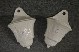 A pair of Continental white pottery wall pockets.
