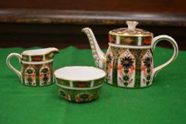 A Royal Crown Derby imari pattern miniature teapot, milk jug and sugar bowl together with a Royal