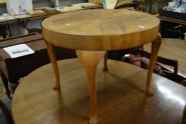 A walnut circular coffee table.