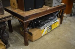 A large Eastern hardwood and wrought iron dining table.