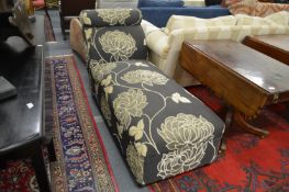 An upholstered daybed ottoman.