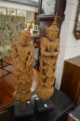 A pair of Thai carved wood figures on stand.